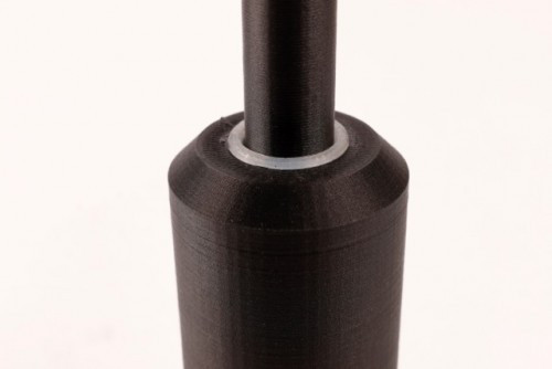 The 3D printed bushing gets added in after a second pause in the print.