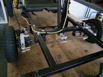 Fiber-reinforced 3D printed steering knuckles on a go-kart.