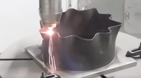 a powder direct energy deposition metal 3D printer in action.