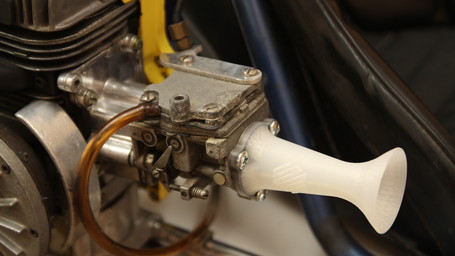 3D printed air intake restrictor.