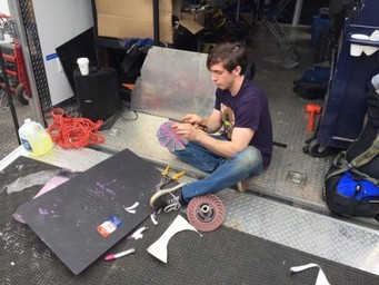 An Olin Baja member fashions an impeller on the fly during a competition